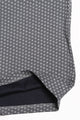 Close-up of a gray fabric with a small white geometric pattern, showing a folded hem that reveals a dark navy lining.