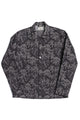 Black and navy Tapi Overshirt Denim Flower with blue floral pattern, button-up long sleeves, and classic collar, crafted from Italian luxury mill overstock fabric.